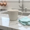 This white ceramic cup is a simple household water cup with a smooth glaze surface after high-temperature firing Application Scenario